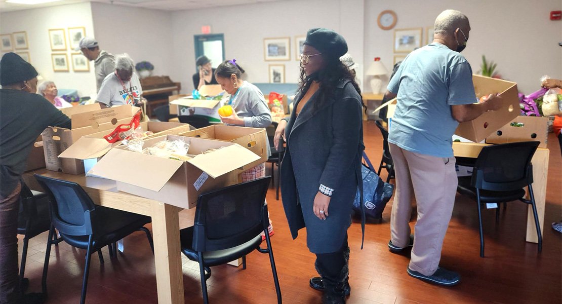 Volunteers preparing boxes for donation to our residents